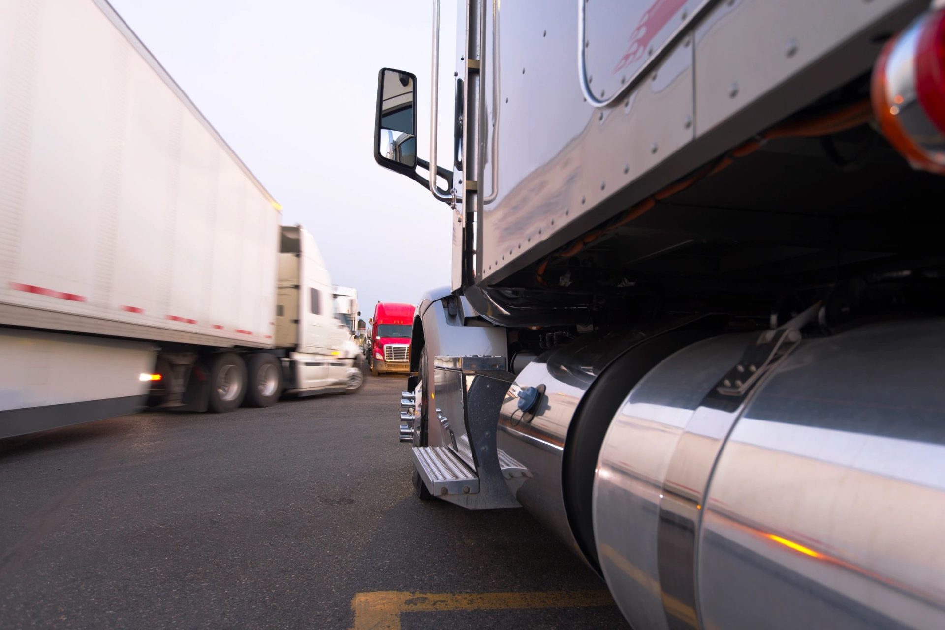 A semi truck is parked on the side of the road.